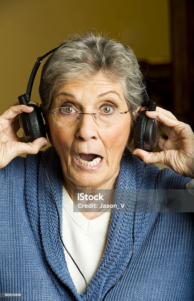 Shocked Grandmother A grandmother with headphones looking shocked Headphones Stock Photo