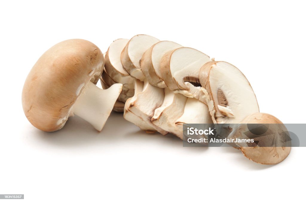 Chestnut Mushroom sliced Two chestnut mushrooms, one sliced, isolated on awhite background. Arrangement Stock Photo