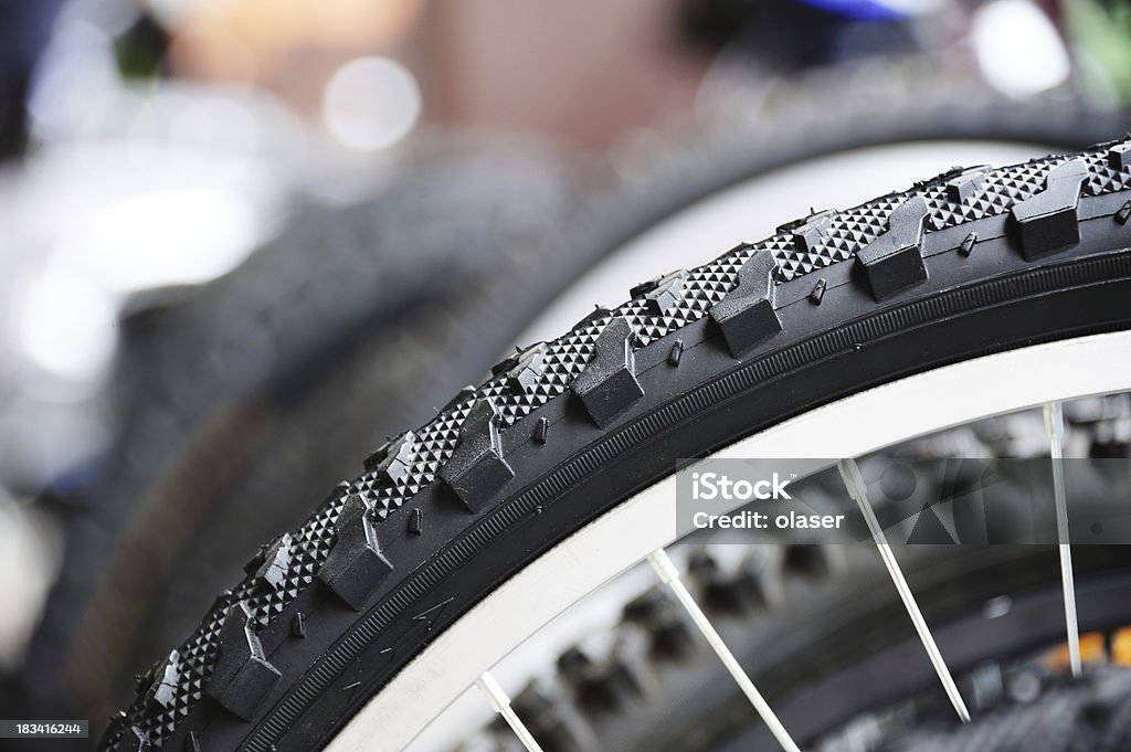 Close up of bicycle tyre, bikes in background Bikes seen form side. Aluminum Stock Photo