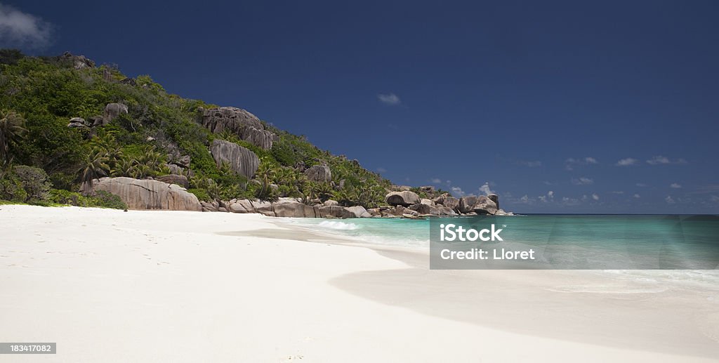 Tropical island paradise beach "Tropical island paradise beach with turquoise sea. Typical seychelles rocks, palm trees and wild nature. YOU MIGHT ALSO LIKE THIS:" Beach Stock Photo