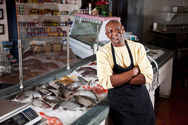 istock Worker behind counter in fish market 183417120
