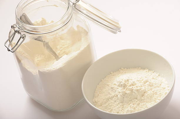 Flour in glass jar and ready for use in a bowl