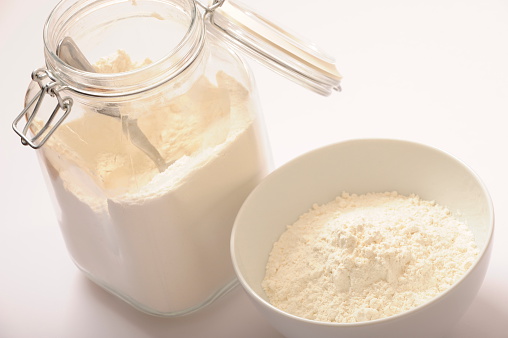Flour in glass jar and ready for use in a bowl