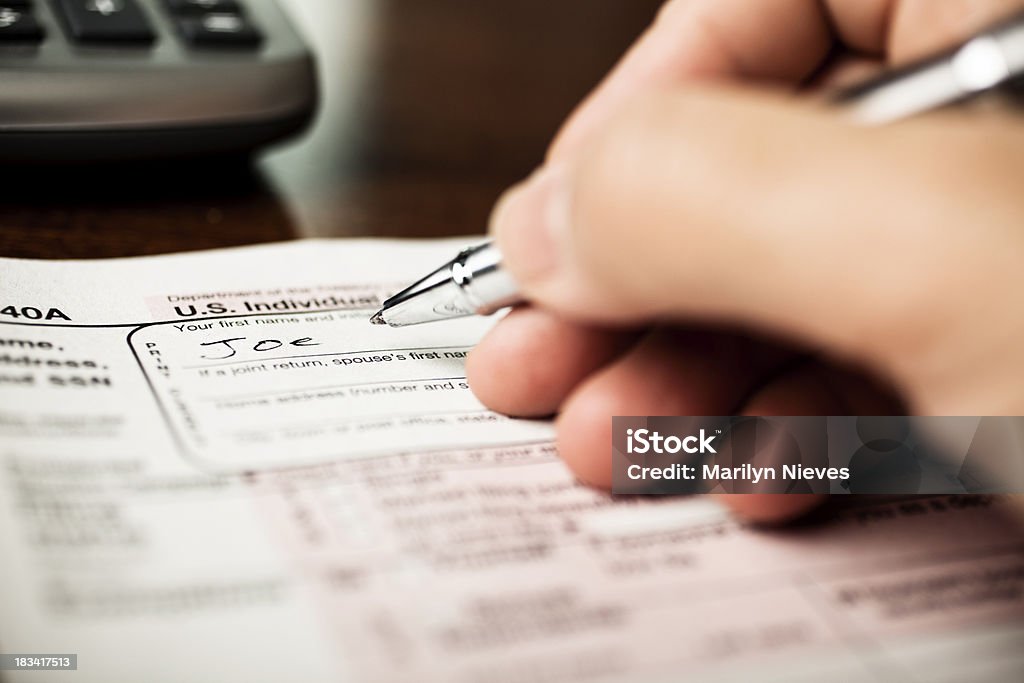 filling out tax forms tax preparation. 1040 Tax Form Stock Photo