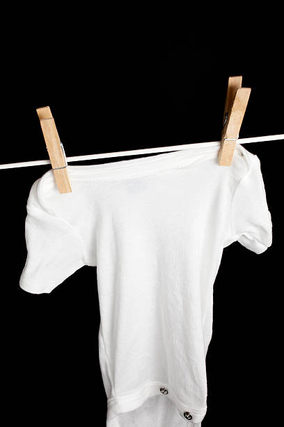 istock Newborn Baby Clothes Hanging on Clothesline 183417657