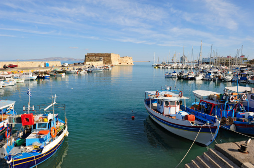 Port of Iraklion with fishing boat and the Fort of Koules in background.See other Mediterranean countries: