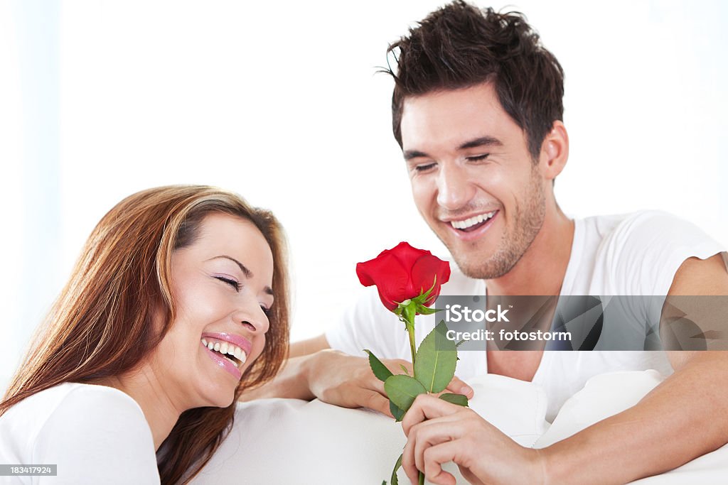 Happy loving couple with red rose Happy loving couple with red rose smiling, having fun together for Valentine's day. 30-39 Years Stock Photo