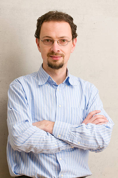 istock Man with glasses posing with arms crossed 183418462