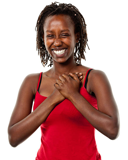 feliz mujer joven con las manos sobre el pecho - hand on heart fotografías e imágenes de stock