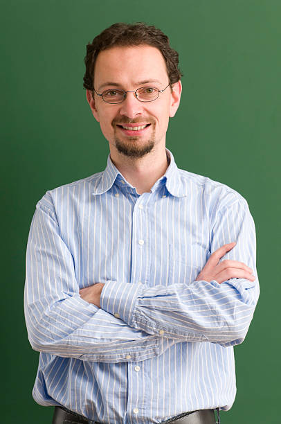 istock A teacher standing with arms crossed while smiling as well  183419192