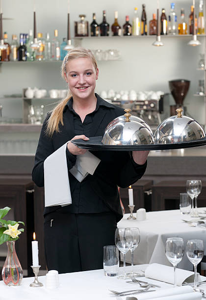 istock waitress holding serving tray in restaurant 183420484