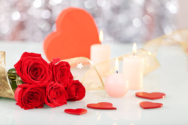 istock Red roses, heart shaped gift box, candles and ribbon 183420560