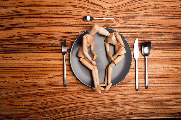 istock two wooden puppets on a plate 183421165