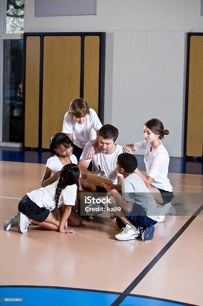 Gruppo eterogeneo di ragazzi in palestra con allenatore - Foto stock royalty-free di 10-11 anni