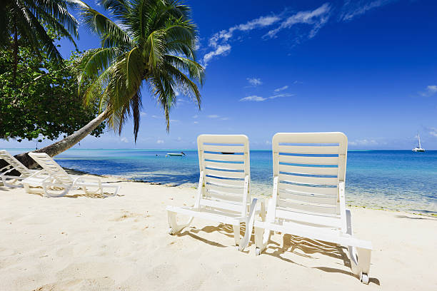 istock Relaxing Tropical Holidays Lounge Chairs at the Beach 183422062