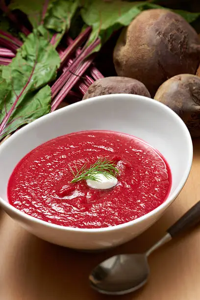 "Bowl of puree beet soup made with a beet and tomato base and vegetable broth, garnished with sour cream and dill.Shot with Nikon D3X and shift lens.My Food Lightboxes"