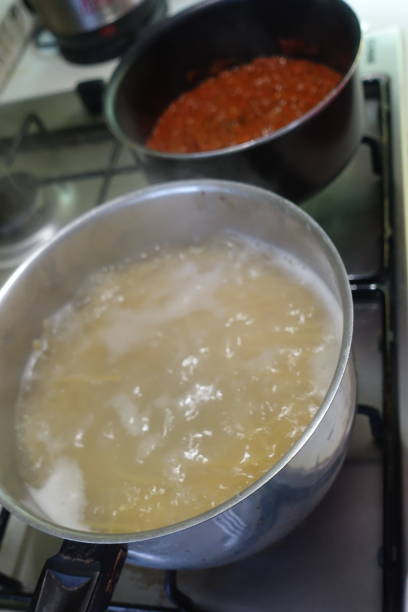 istock Spaghetti Bolognese sauce being cooked in pans on a hob 1834230755