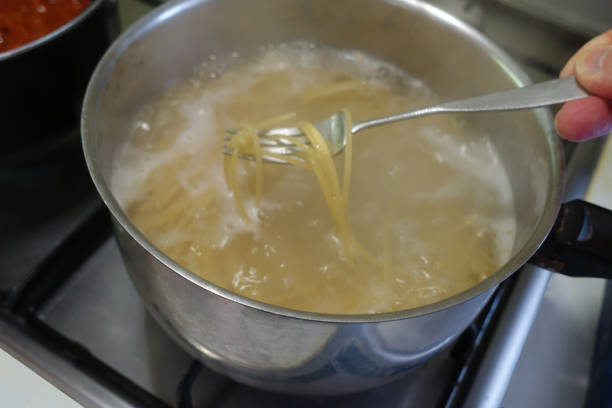istock Spaghetti Bolognese sauce being cooked in pans on a hob 1834230763