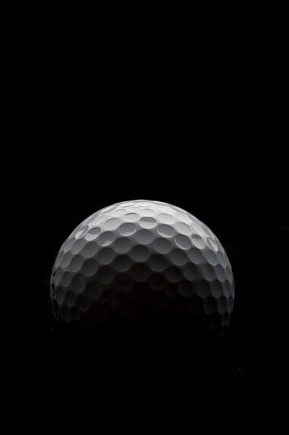 Backlit golf ball Backlit golf ball on a black background. Image fades to total black. golf ball photos stock pictures, royalty-free photos & images