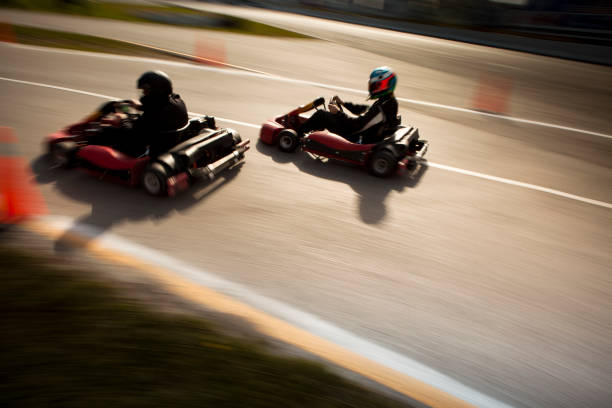 Competitive go-cart racing blurred Go cart drivers racing on track go carting stock pictures, royalty-free photos & images