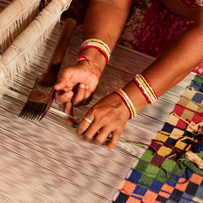 Indian man weaving durries. The durry (Rug) is weaved out of cotton or wool, The geometric designs are produced by tapestry technique which is a slow process using separate bobbins or butterflies for each colour across the width interlocking with the adjacent coloured yarn.  This old fashined form of weaving is very popular in Rajasthan, specially in Salawas village near Jodhpur.http://bem.2be.pl/IS/rajasthan_380.jpg