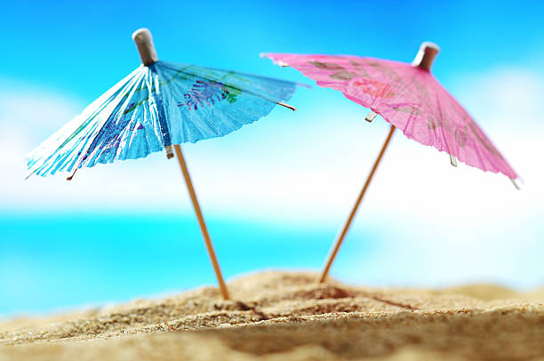 Cocktail umbrellas on the beach Cocktail umbrellas  on the beach  - selective focus drink umbrella stock pictures, royalty-free photos & images