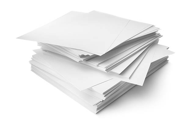 Two sheets of checkered paper held together with a white paper clip isolated on white. Empty memo pad.\nBlank exercise book page. Document or shopping list mockup. Invoice with copy space. Note background.