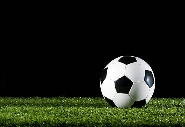istock Soccer ball on the grass at night 183424734
