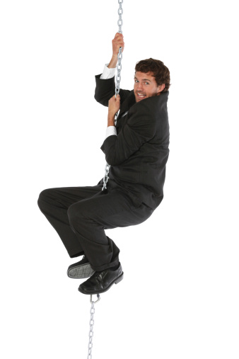 Businessman hanging from a metal chainhttp://www.twodozendesign.info/i/1.png