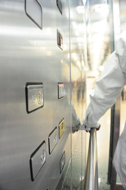 istock Elevator interior. Alarm button in focus. Person exiting. 183424825
