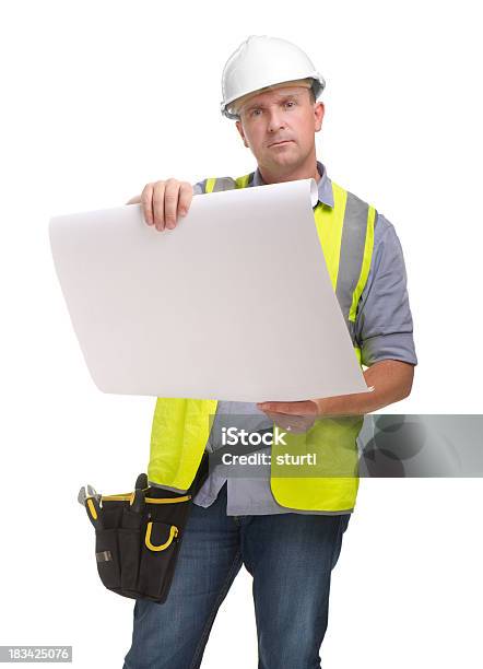 Trabajador De La Construcción Mirando Sobre Los Planes Foto de stock y más banco de imágenes de 40-44 años