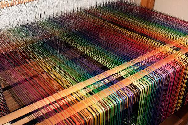 Rainbow-colored threads on a Loom Rainbow-colored threads on a Loom loom stock pictures, royalty-free photos & images