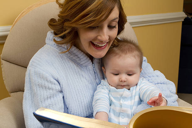 Mother reading to child at bedtime stock photo