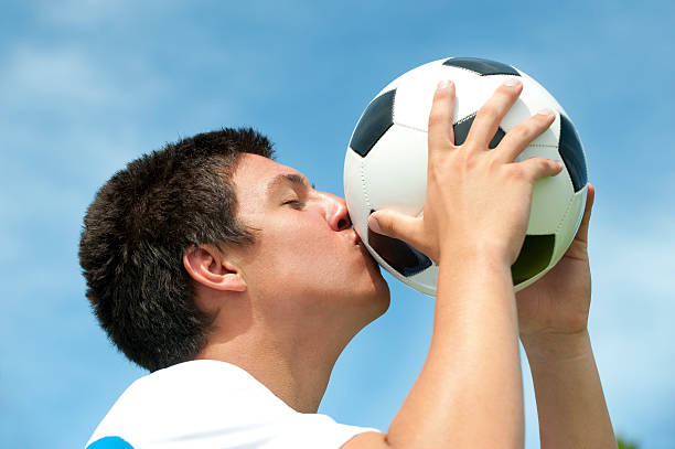 istock Man kissing a soccer ball 183425996