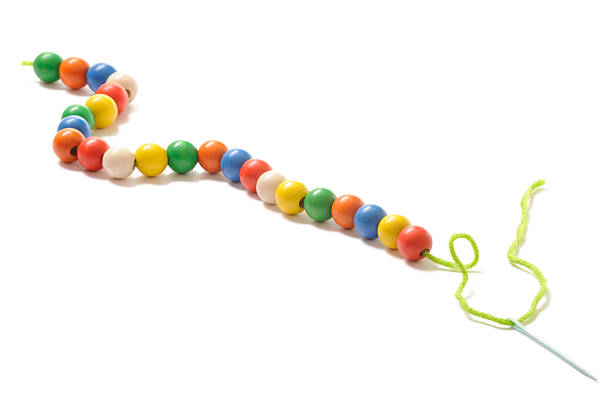 Long chain with colored wooden beads. Isolated on white.