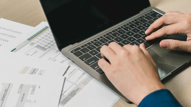 istock a businessman working on financial analysis and paperwork in an office. using a laptop and manage financial documents and conduct analysis. 1834267447