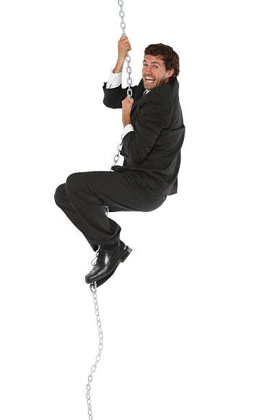 istock Isolated businessman clinging onto rope chain 183426847