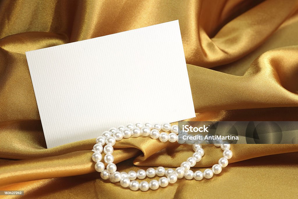 white card with space for text on gold satin Celebration Stock Photo
