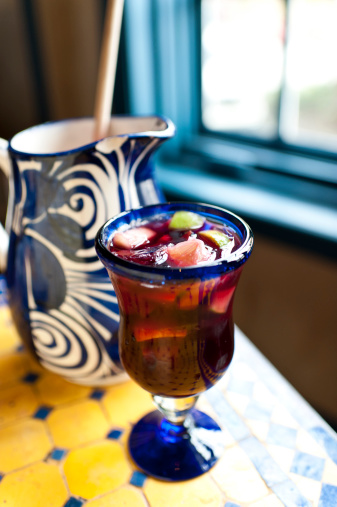 Glass of spanish sangria over a colorful tile table