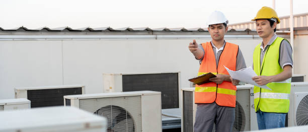 istock Engineers use blueprint check air condition systems on site. Contractor and inspector inspection compressor during project. maintenance team check quality assurance. Audit, inspect, quality control. 1834277816