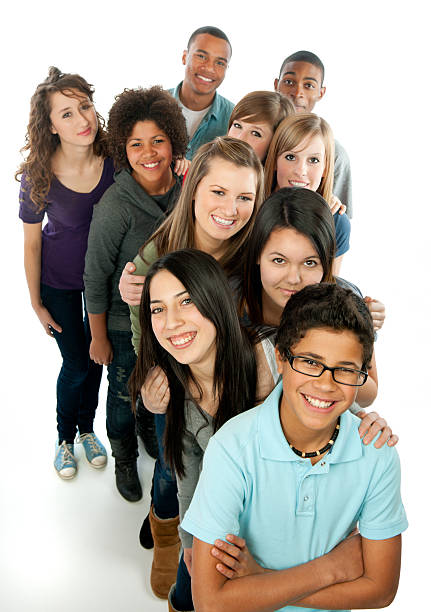 Teens A diverse group of teens standing in a row. teenagers only stock pictures, royalty-free photos & images