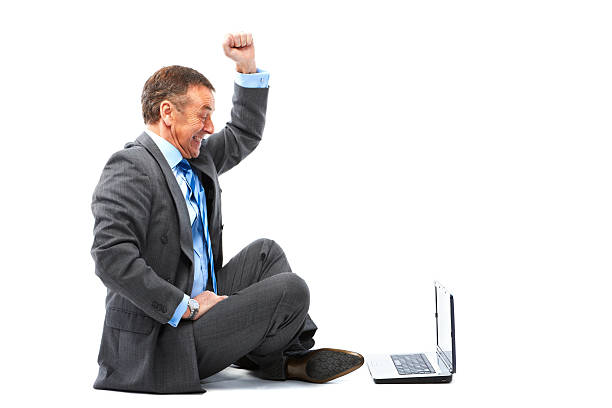 istock Mature sitting man isolated on white background with laptop 183428419