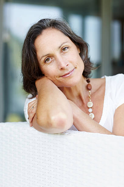 istock Elegant mature woman relaxing on sofa 183428752