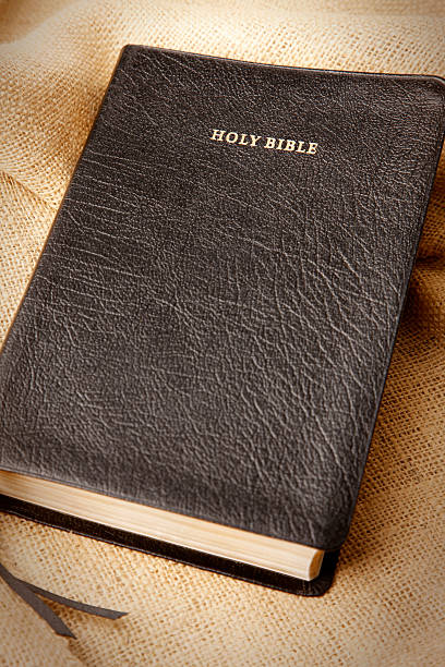 istock Black Leather Holy Bible on Burlap Background 183428998