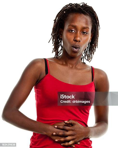 Joven Mujer Con Las Manos En El Estómago Foto de stock y más banco de imágenes de Abdomen - Abdomen, Abdomen humano, Calambres