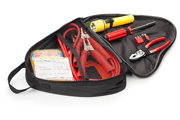 Automotive Emergency Tool Kit "Automotive roadside emergency tool kit isolated on white. Contains emergency supplies such as jumper cables, hand tools, and an emergency sign, in case  of a vehicle break down.Please also see:" jumper cable stock pictures, royalty-free photos & images