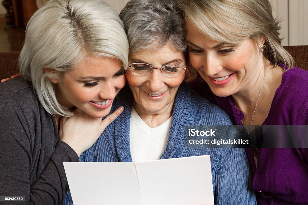 Mujer leyendo una tarjeta de felicitación - Foto de stock de Tercera edad libre de derechos