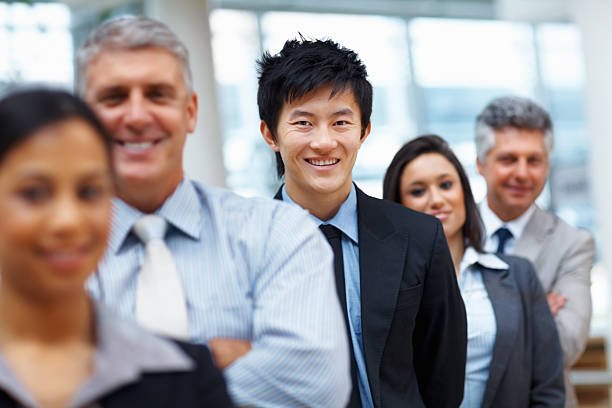 istock Happy male executive with team 183431432