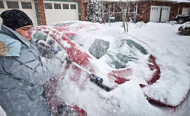 istock Man Cleaning Snow Off Car 183432274