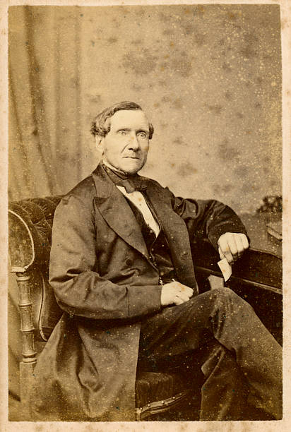 Victorian Gentleman Old Photograph "Vintage faded and damaged photograph of a mature gentleman from the victorian era, circa 1865" 19th century stock pictures, royalty-free photos & images